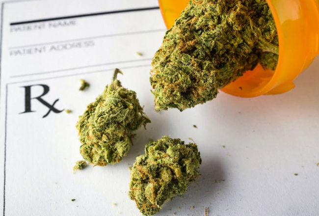 Medical marijuana inside of a prescription bottle on top of a prescription form