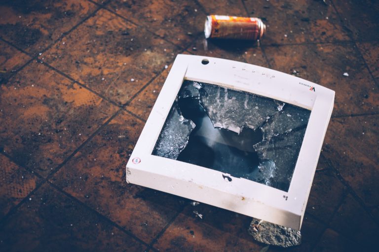 A smashed hospital computer monitor on the ground as a result of workplace violence