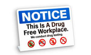 Notice sign stating "this is a drug free workplace" With pictograms of drugs and alcohol that are not allowed. Their policy includes drug testing.
